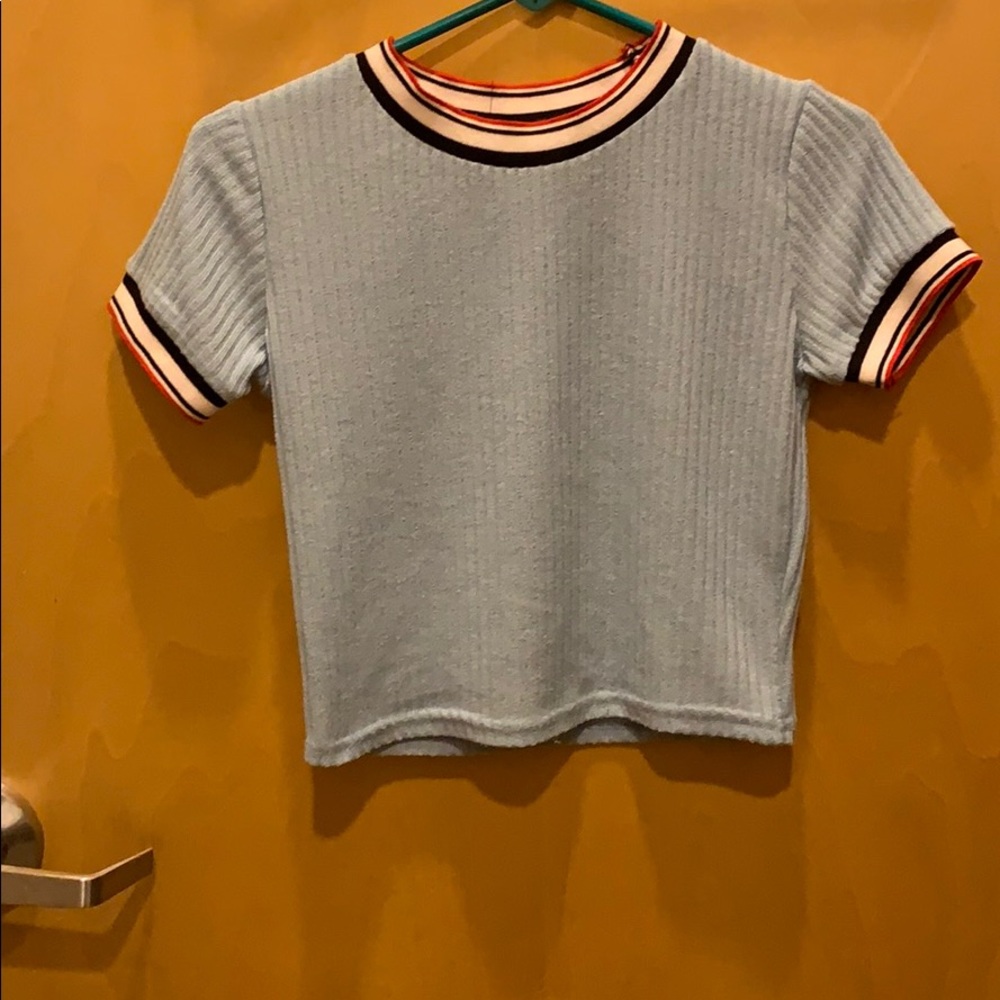 Light blue top with striped collar and sleeves.